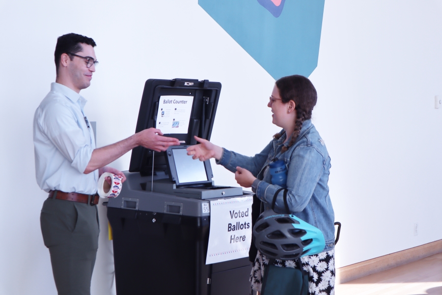 voter putting ballot into the tabulator